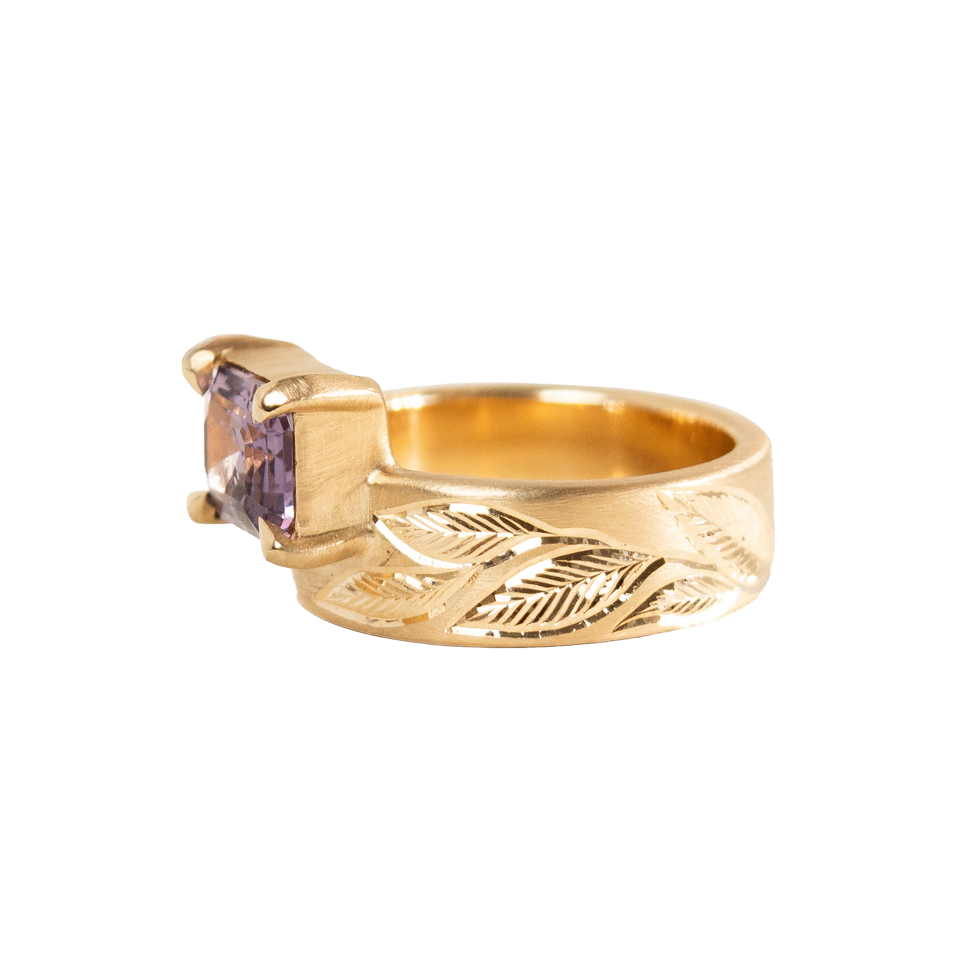 A 14k yellow gold ring featuring a rectangular emerald-cut light purple sapphire set against a plain white background.