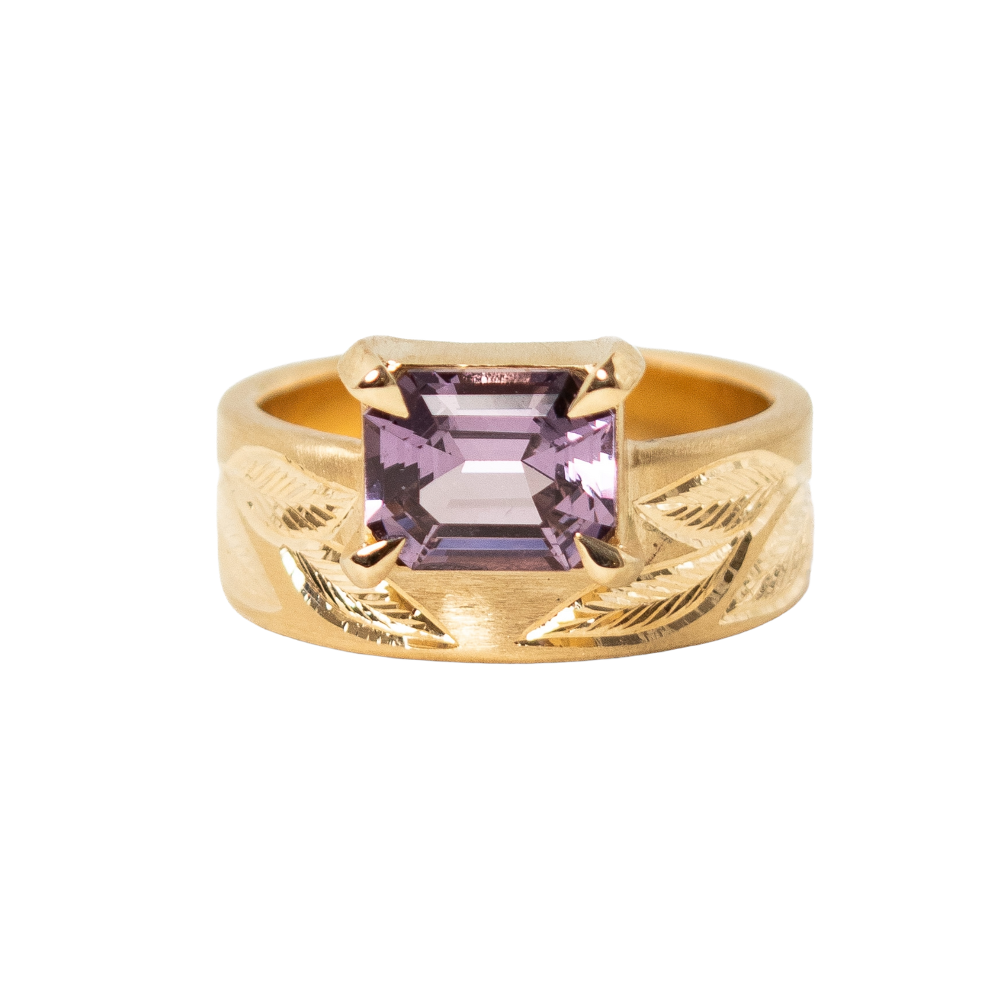 A 14k yellow gold ring featuring a rectangular emerald-cut light purple sapphire set against a plain white background.